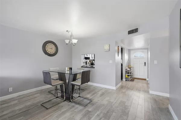 a view of a room with furniture and wooden floor