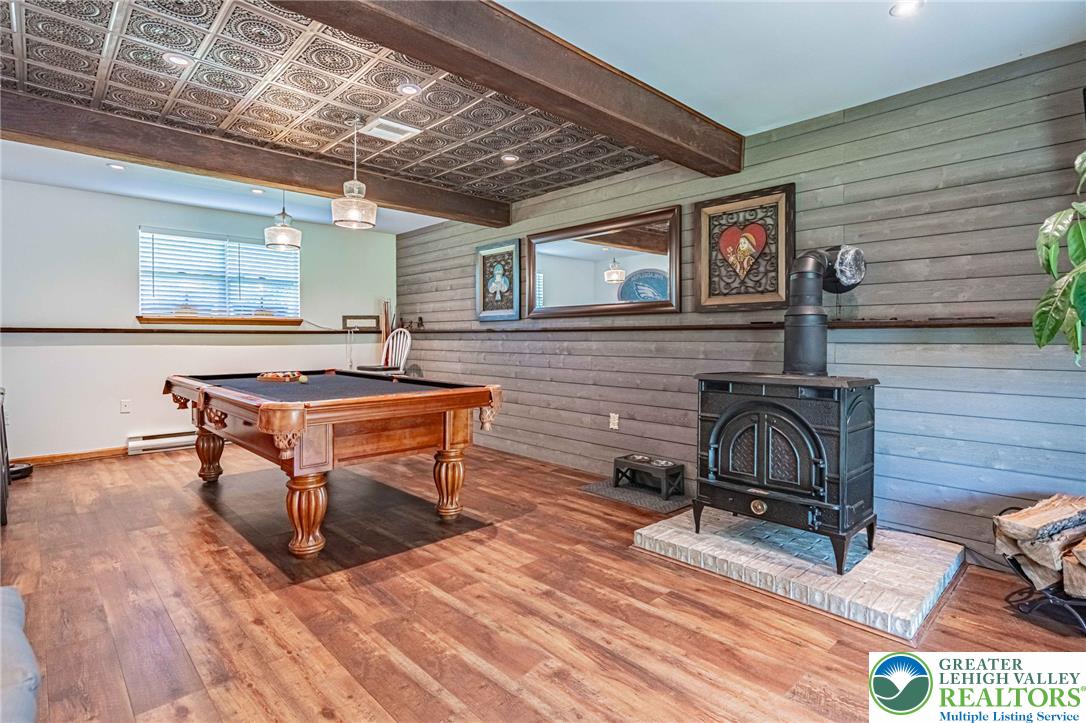 341 Lower Greenhill Road Kunkletown, PA 18058 - Photo 36 of 69 A classic wood-burning stove provides warmth in this spacious recreation area featuring durable wood flooring and decorative tin ceiling.