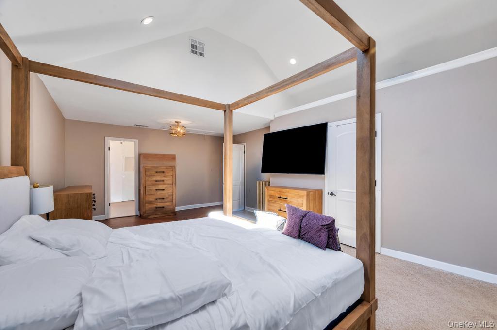 357 Wynsum Avenue Merrick, NY 11566 - Photo 32 of 40 a bedroom with a bed and a flat screen tv