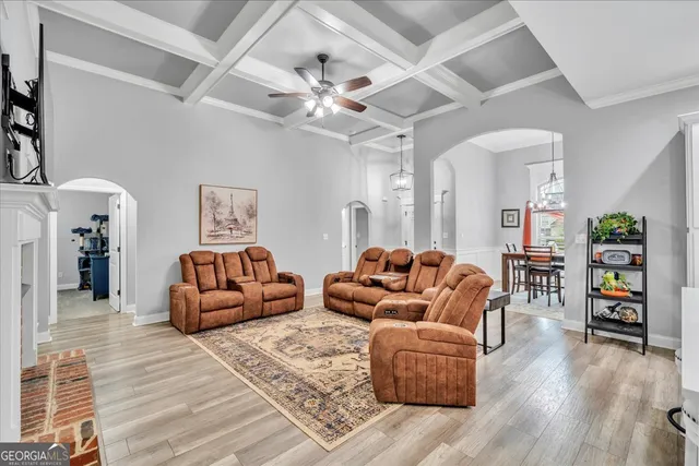 a living room with furniture and a wooden floor