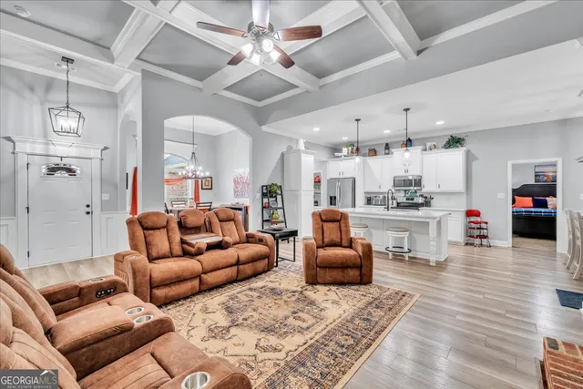 a living room with furniture and kitchen view