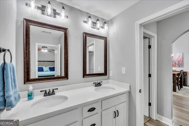 a bathroom with a double vanity sink mirror and