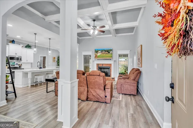 a living room with furniture and a chandelier