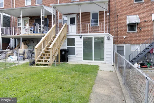a view of a house with a yard and stairs