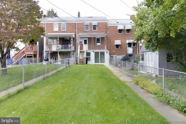 a view of a house with a yard and sitting area