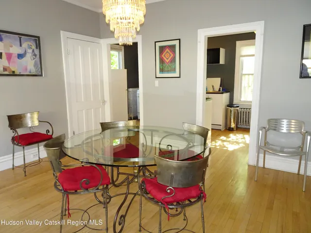 a living room with furniture a window and wooden floor