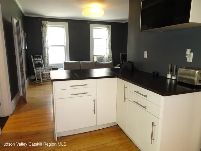 a kitchen with stainless steel appliances granite countertop a sink a stove top oven a counter space and cabinets