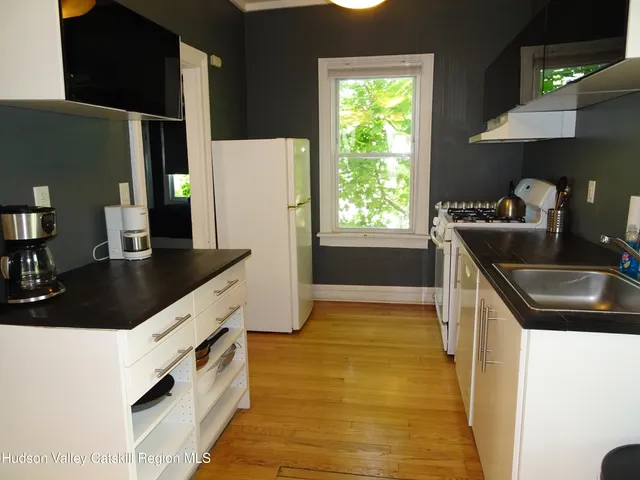 a kitchen with stainless steel appliances a sink stove and refrigerator