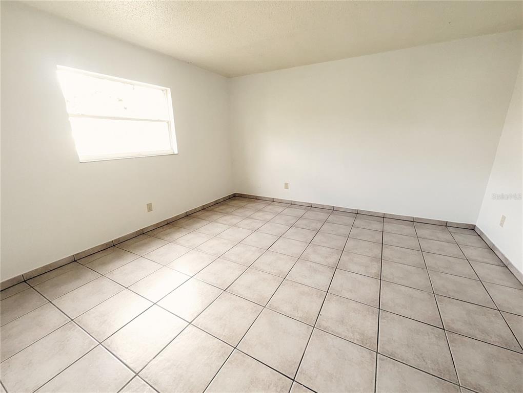 4520 68th Street West, Unit B Bradenton, FL 34210 - Photo 6 of 8 an empty room with windows