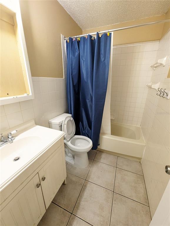 4520 68th Street West, Unit B Bradenton, FL 34210 - Photo 8 of 8 a bathroom with a sink a toilet a mirror and shower