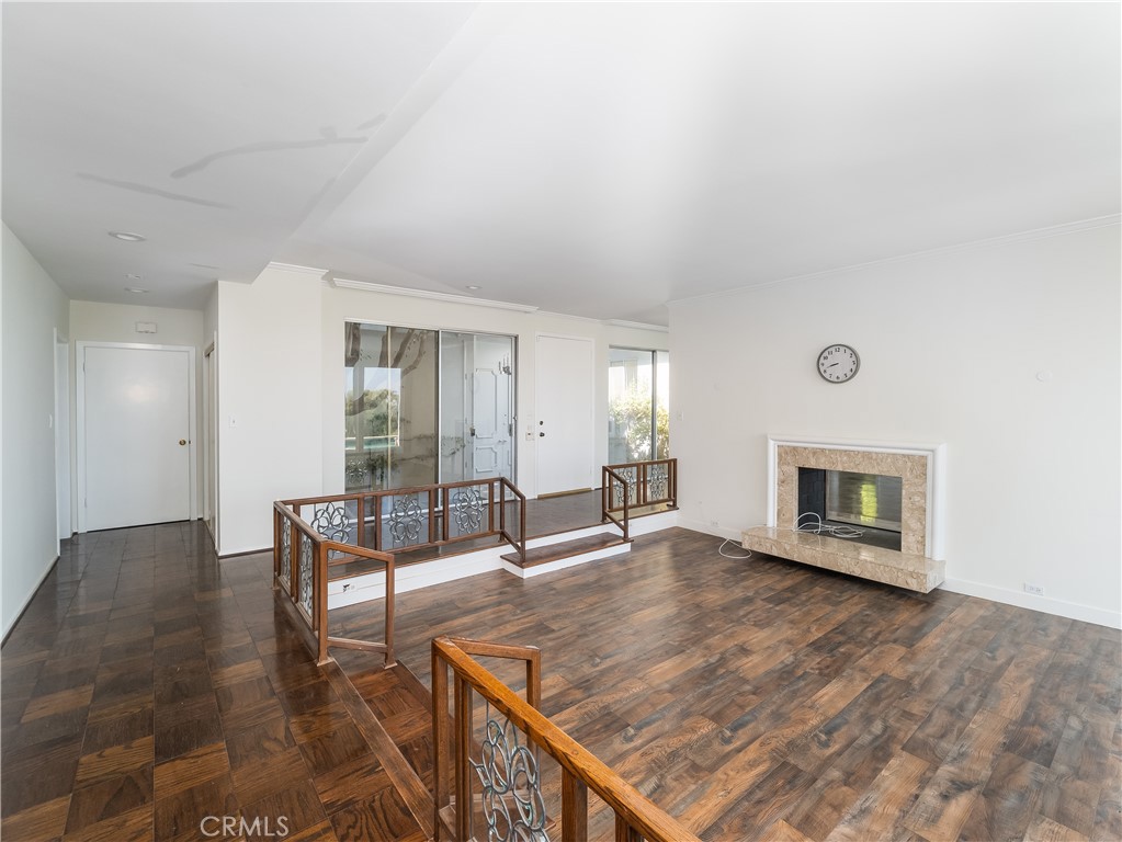 20193 Adele Drive Woodland Hills, CA 91364 - Photo 15 of 38 an empty room with fireplace and wooden floor