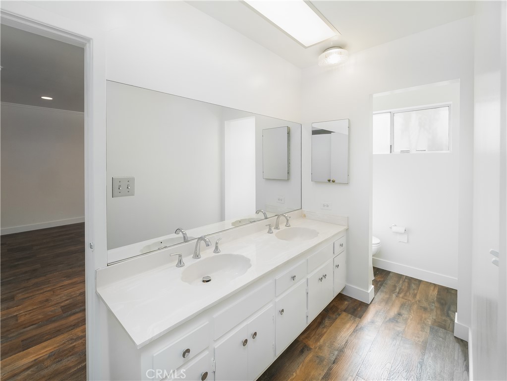 20193 Adele Drive Woodland Hills, CA 91364 - Photo 18 of 38 a spacious bathroom with a double vanity sink and mirror