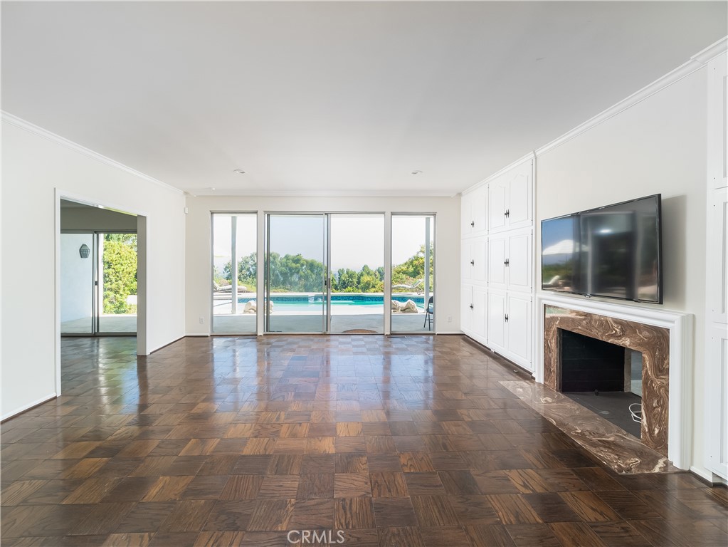 20193 Adele Drive Woodland Hills, CA 91364 - Photo 2 of 38 a view of empty room with wooden floor and fireplace