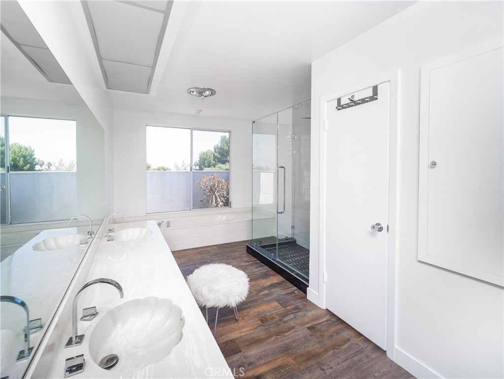 20193 Adele Drive Woodland Hills, CA 91364 - Photo 22 of 38 a bathroom with a tub sink and mirror