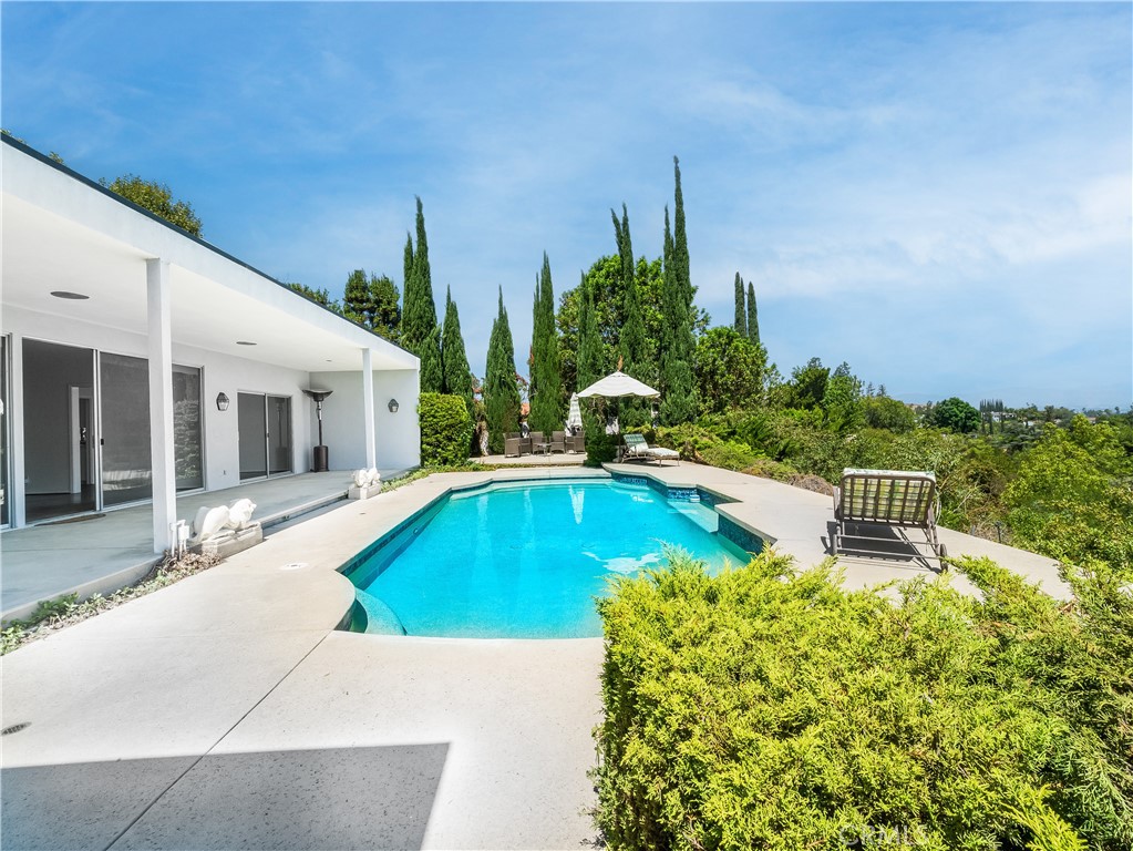20193 Adele Drive Woodland Hills, CA 91364 - Photo 27 of 38 a swimming pool with outdoor seating and yard