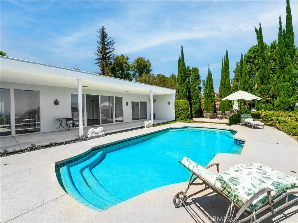 20193 Adele Drive Woodland Hills, CA 91364 - Photo 28 of 38 a view of a house with swimming pool and sitting area