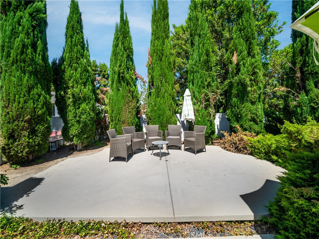 20193 Adele Drive Woodland Hills, CA 91364 - Photo 32 of 38 a view of a patio with table and chairs potted plants and large tree