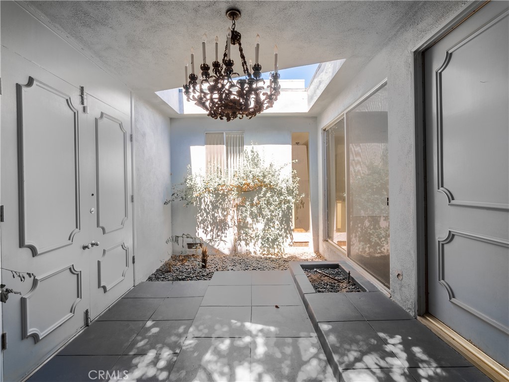 20193 Adele Drive Woodland Hills, CA 91364 - Photo 38 of 38 a view of a hallway with windows and chandelier