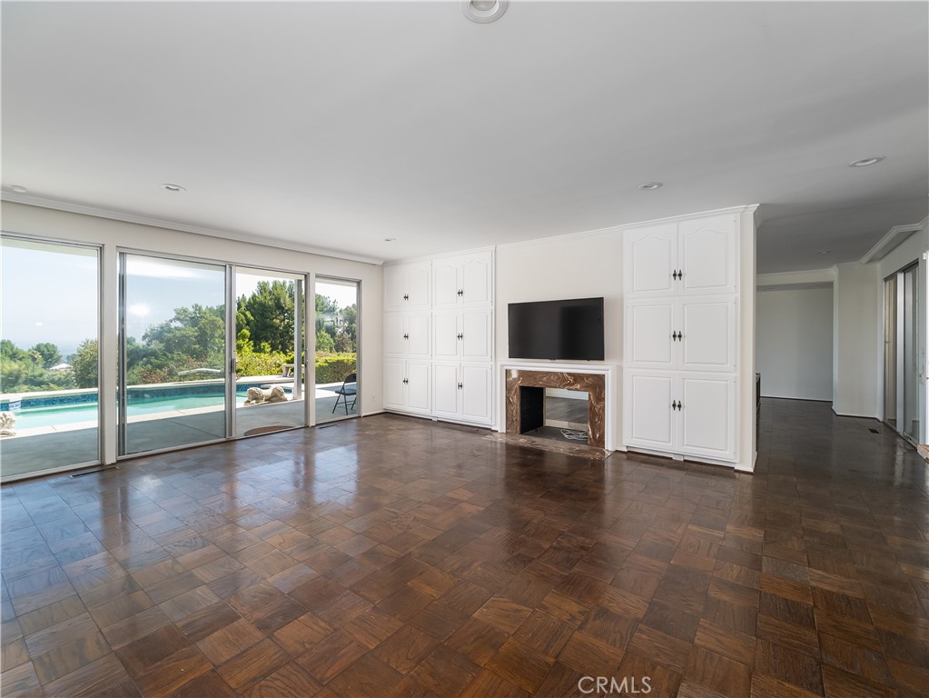 20193 Adele Drive Woodland Hills, CA 91364 - Photo 4 of 38 a view of an empty room with window and a fireplace