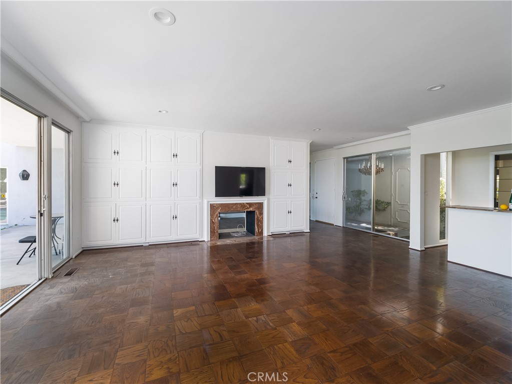 20193 Adele Drive Woodland Hills, CA 91364 - Photo 5 of 38 an empty room with wooden floor and fireplace