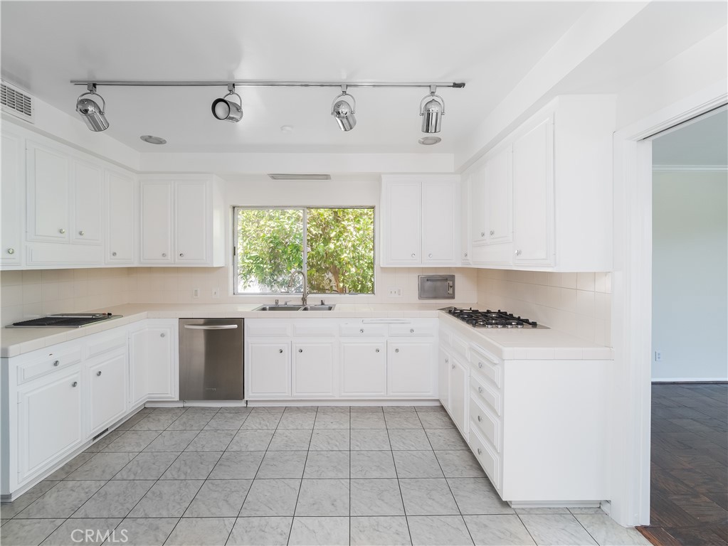 20193 Adele Drive Woodland Hills, CA 91364 - Photo 9 of 38 a kitchen with a stove top oven sink and cabinets