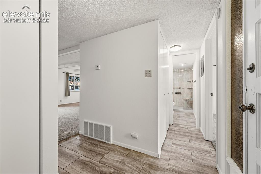 1018 Fontmore Road, Unit A Colorado Springs, CO 80904 - Photo 7 of 28 a view of hallway with wooden floor