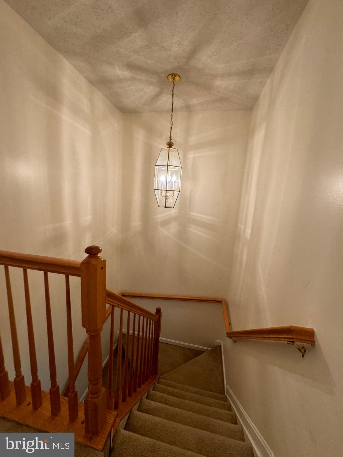 1604 Briarview Court, Unit 64 Severn, MD 21144 - Photo 10 of 24 Inviting staircase with warm lighting glow.