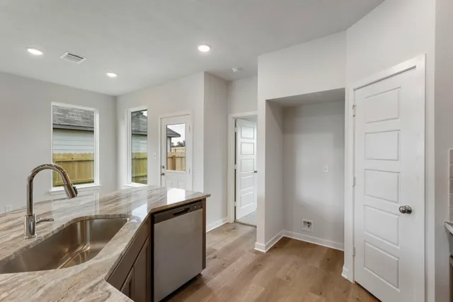 a kitchen with a sink and a refrigerator