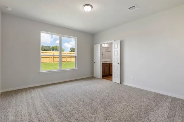 an empty room with windows and closet
