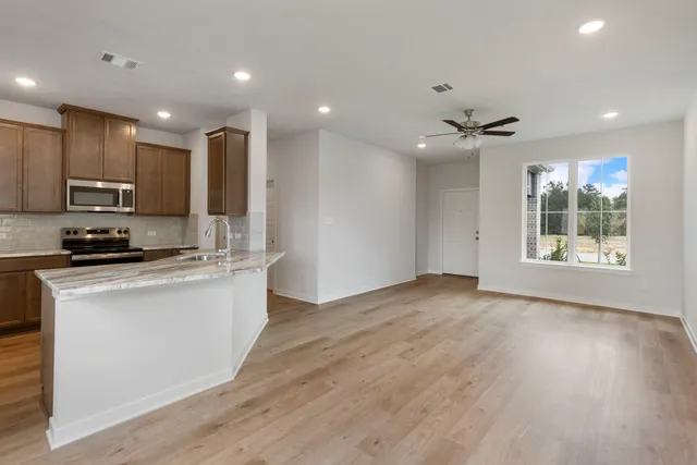 a view of kitchen with microwave and refrigerator