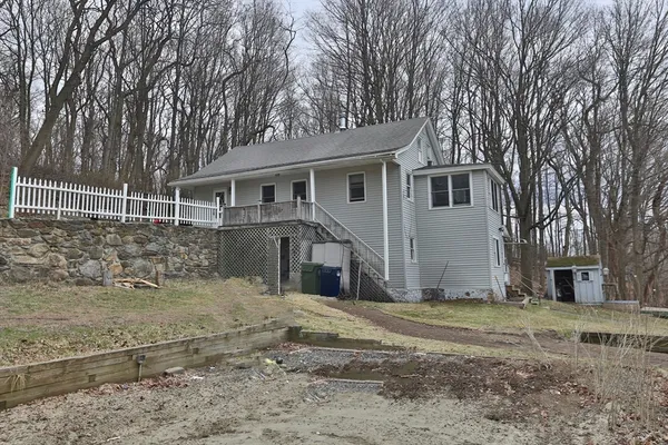a view of a house with a yard covered in snow