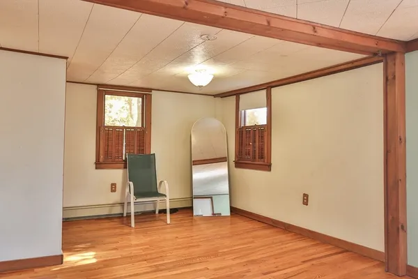 a view of a room with wooden floor and furniture