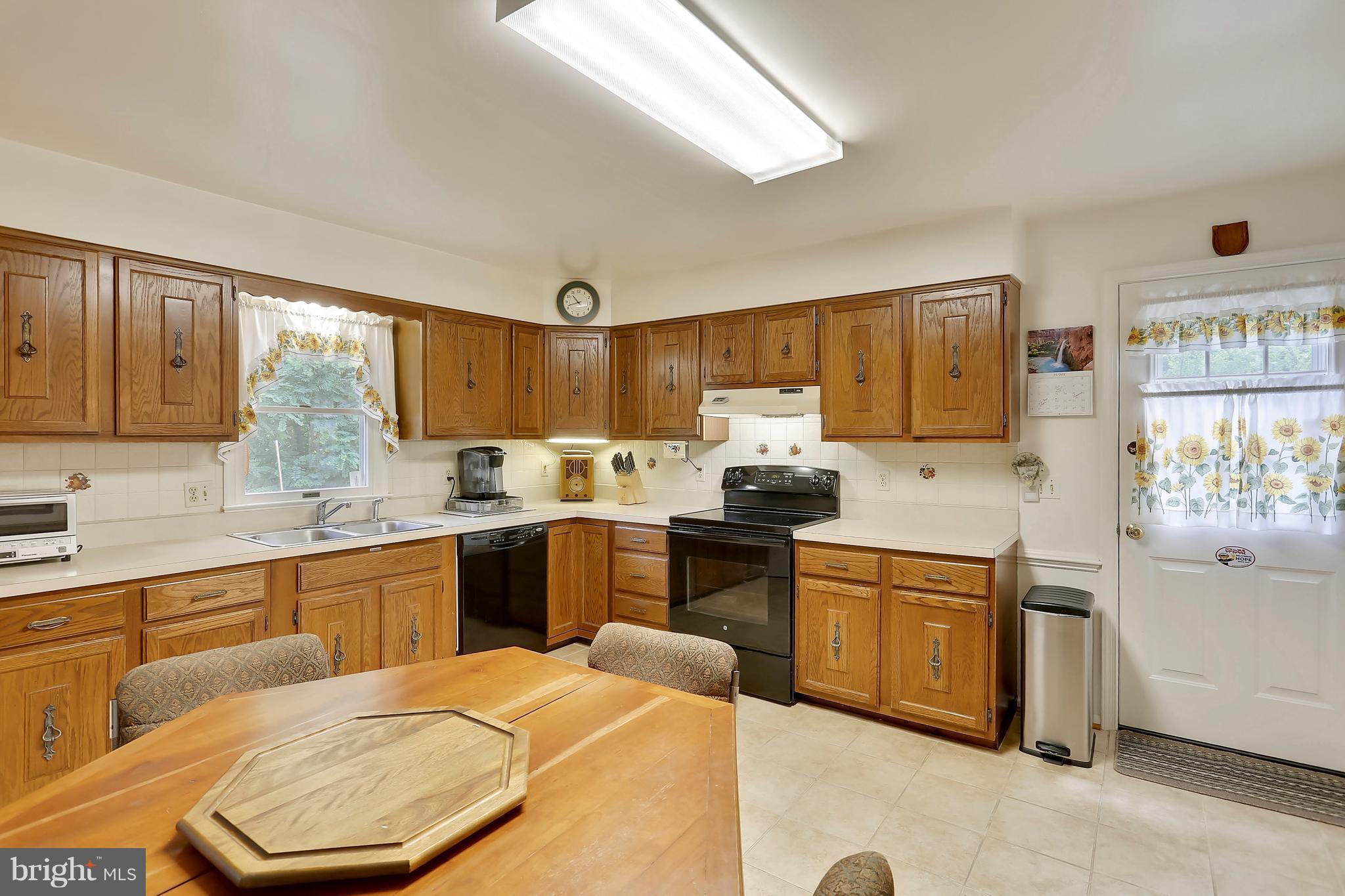 464 Friendship Road Friendship, MD 20758 - Photo 12 of 29 a kitchen with stainless steel appliances kitchen island granite countertop a sink and cabinets