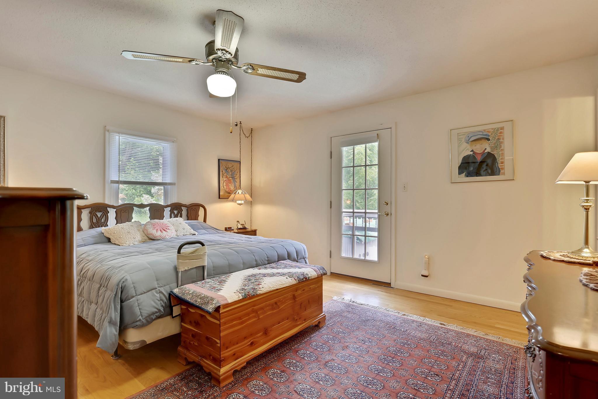 464 Friendship Road Friendship, MD 20758 - Photo 14 of 29 a spacious bedroom with a bed and a chandelier