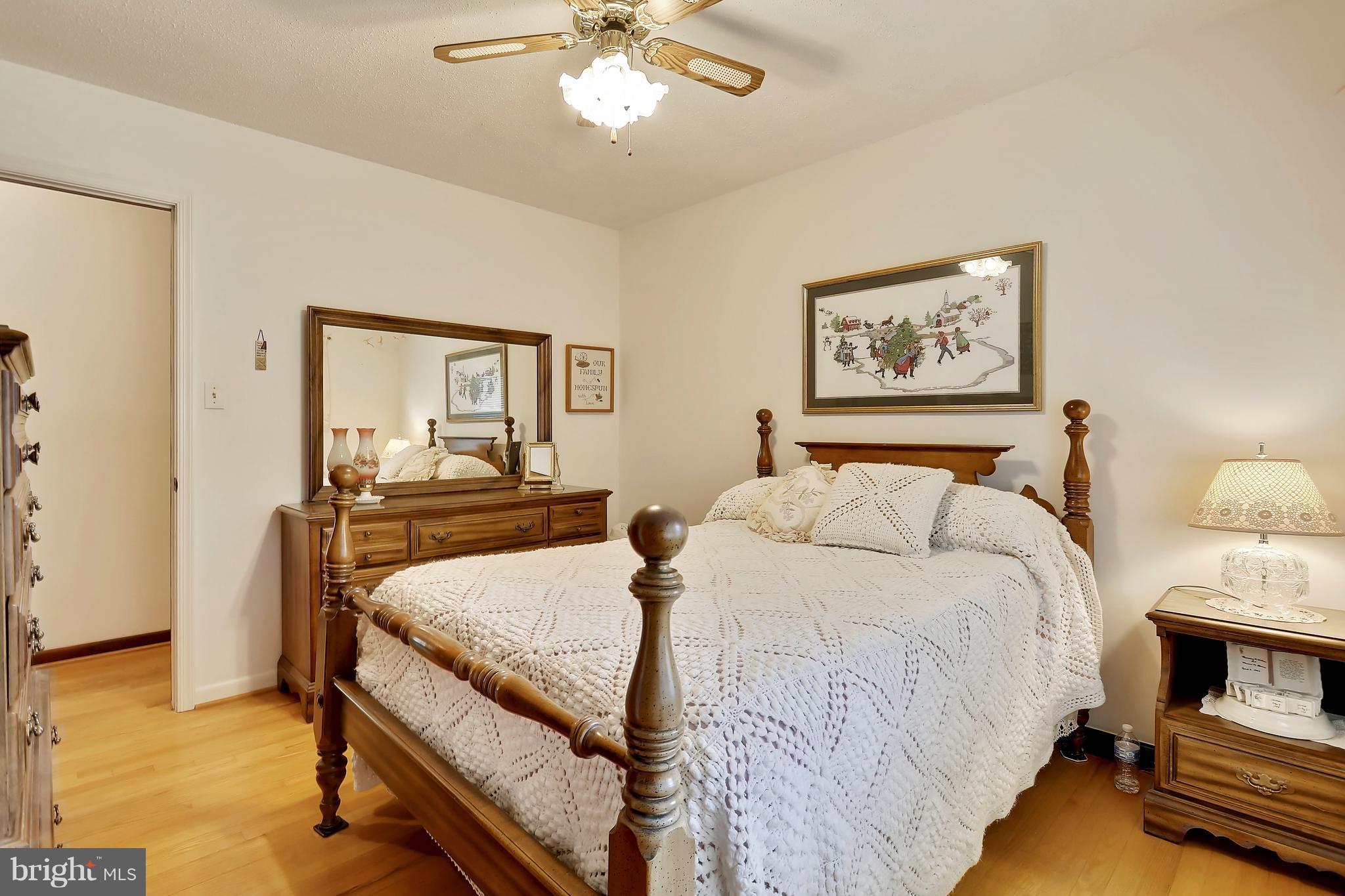 464 Friendship Road Friendship, MD 20758 - Photo 20 of 29 a bedroom with a bed and a chandelier