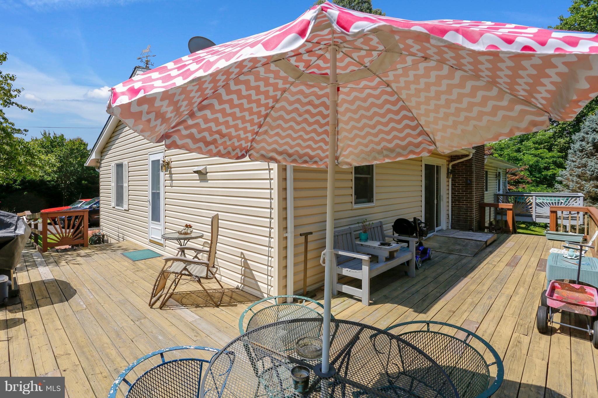 464 Friendship Road Friendship, MD 20758 - Photo 24 of 29 a blue and white umbrella sitting in front of a house
