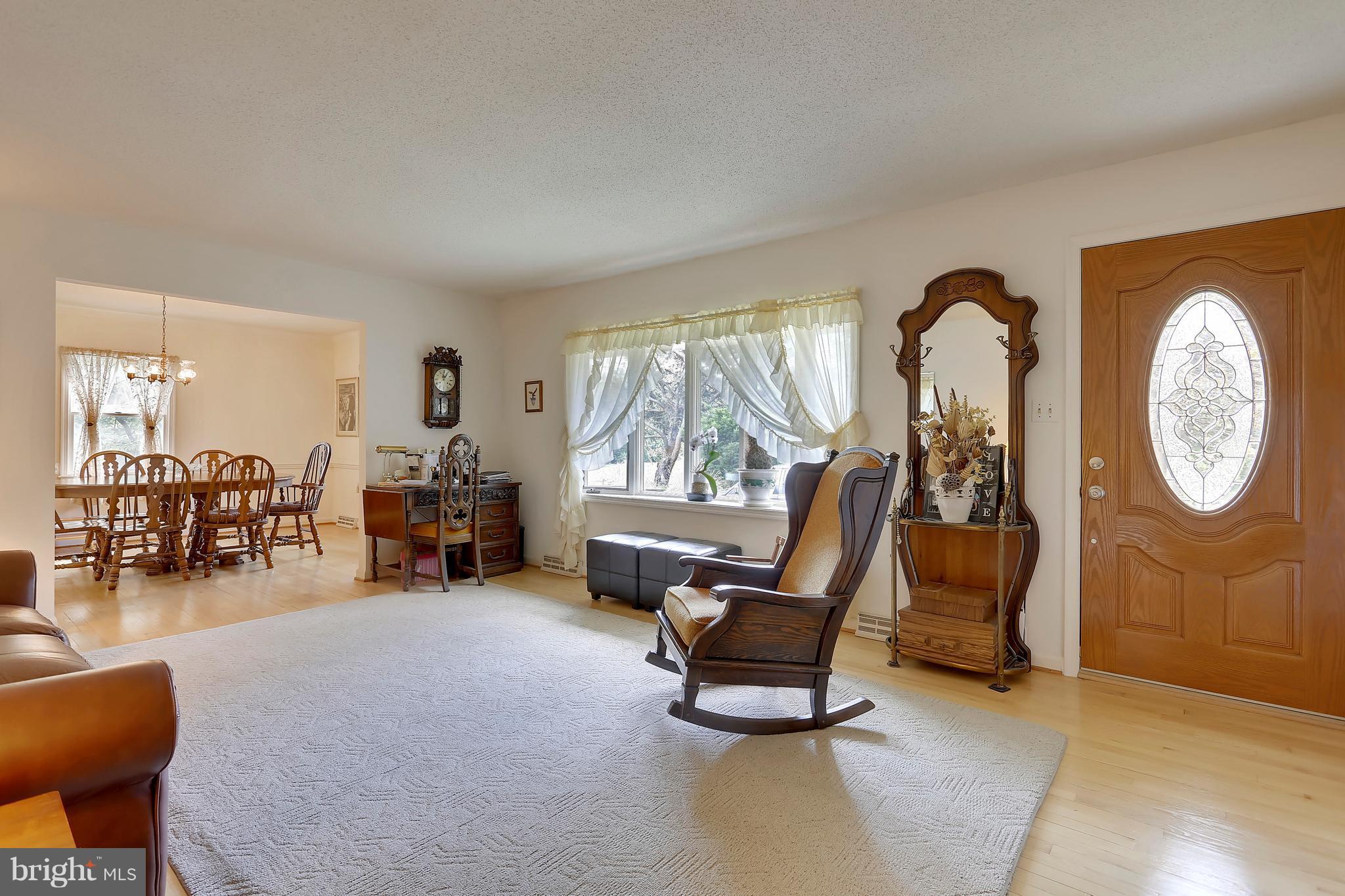 464 Friendship Road Friendship, MD 20758 - Photo 8 of 29 a living room with furniture a clock and a large window
