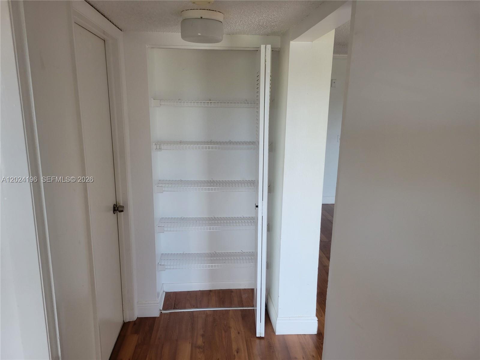8260 Southwest 210th Street, Unit 319 Cutler Bay, FL 33189 - Photo 15 of 20 a view of walk in closet with empty racks