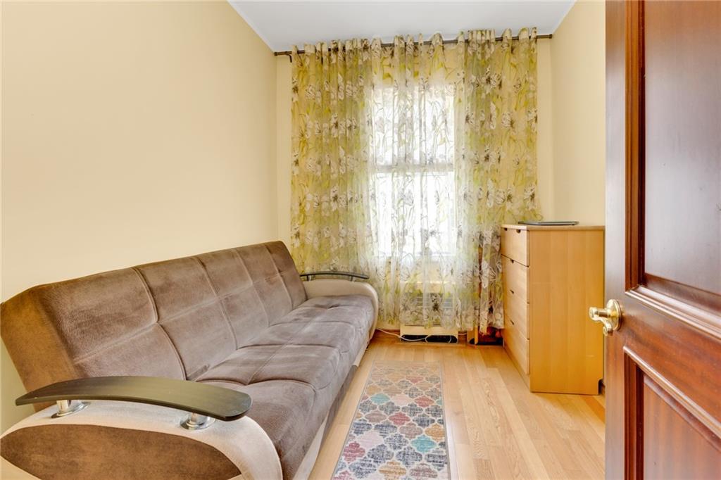 449 Ave Y Brooklyn, NY 11223 - Photo 11 of 25 a living room with a couch and a table