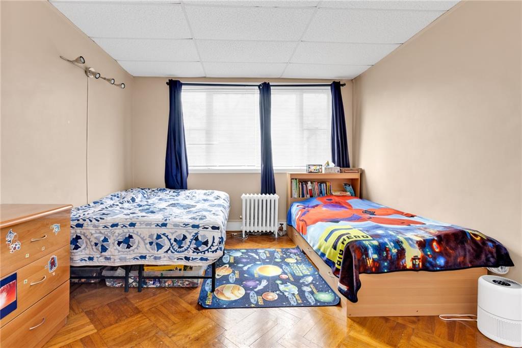 449 Ave Y Brooklyn, NY 11223 - Photo 16 of 25 a bedroom with two beds and a dresser
