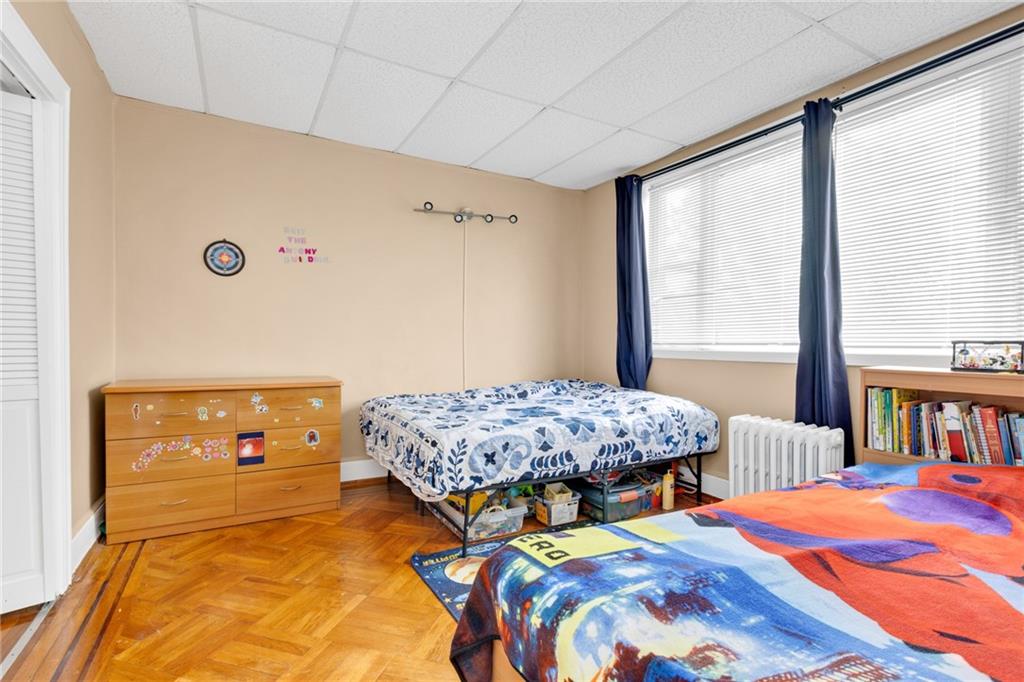 449 Ave Y Brooklyn, NY 11223 - Photo 17 of 25 a bedroom with bed and a window
