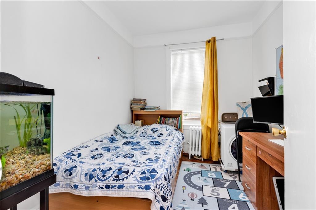 449 Ave Y Brooklyn, NY 11223 - Photo 19 of 25 a bedroom with a bed and a window