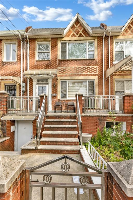 449 Ave Y Brooklyn, NY 11223 - Photo 23 of 25 a view of a house with a small yard and wooden floor and fence