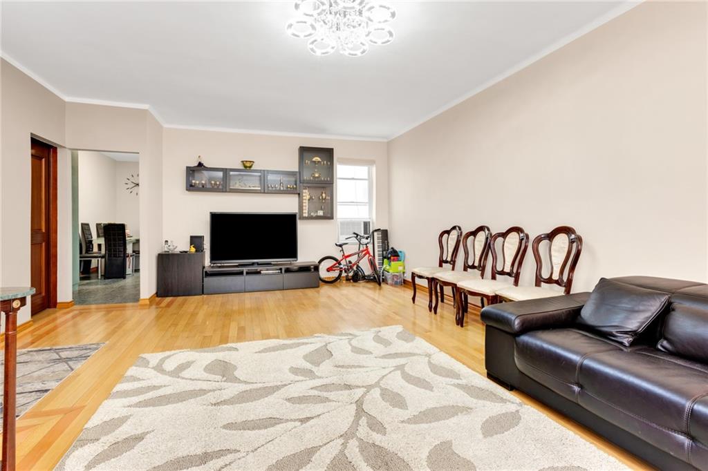 449 Ave Y Brooklyn, NY 11223 - Photo 3 of 25 a living room with furniture and a fireplace