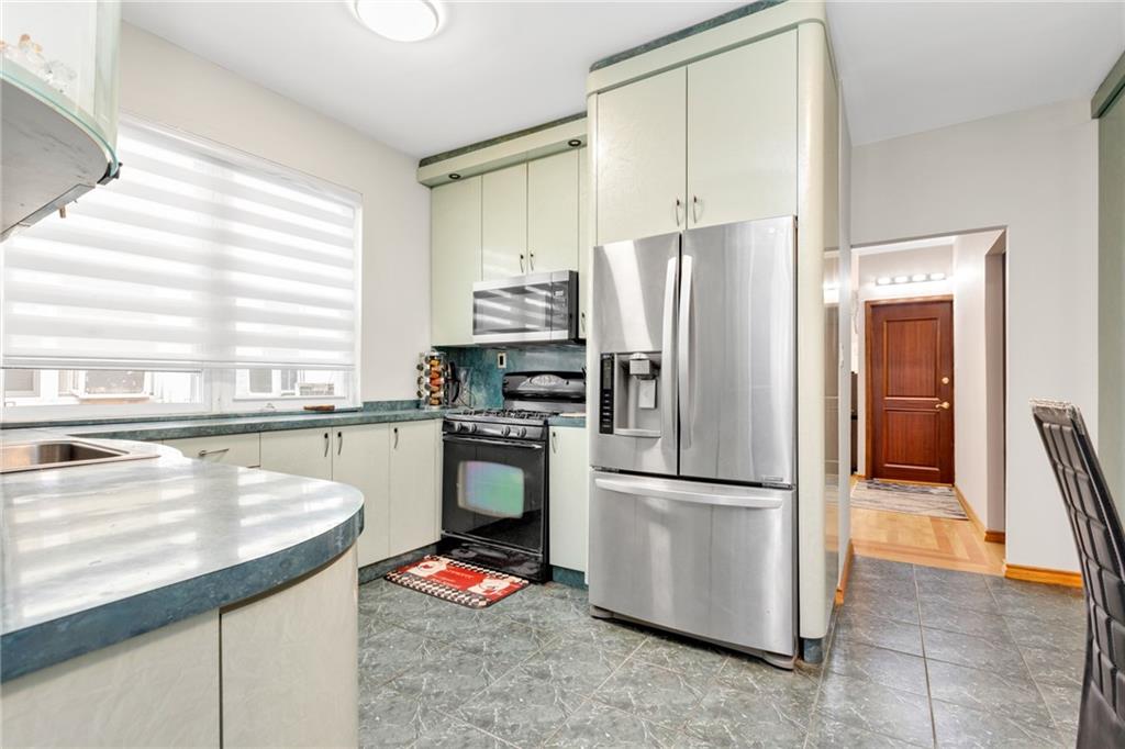 449 Ave Y Brooklyn, NY 11223 - Photo 8 of 25 a kitchen with a refrigerator a sink and a stove
