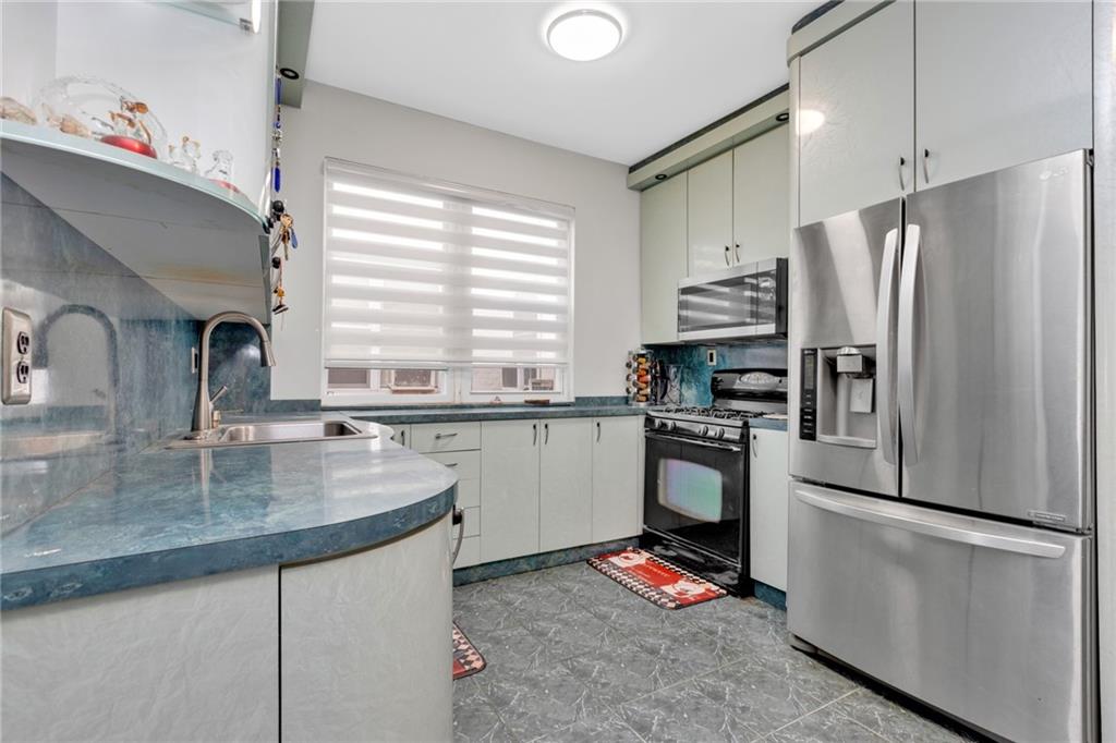 449 Ave Y Brooklyn, NY 11223 - Photo 9 of 25 a kitchen with stainless steel appliances granite countertop a refrigerator sink stove and refrigerator