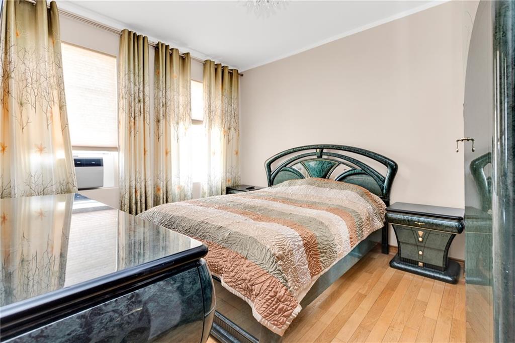 449 Ave Y Brooklyn, NY 11223 - Photo 10 of 25 a bedroom with a bed and a large window