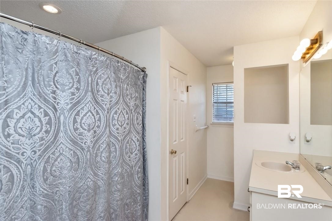 6601 Conde Court Mobile, AL 36695 - Photo 19 of 30 Bathroom featuring a textured ceiling and vanity