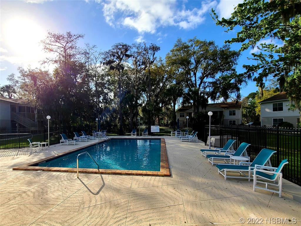 1600 Big Tree Road, Unit K3 South Daytona, FL 32119 - Photo 3 of 4 a swimming pool with outdoor seating and yard