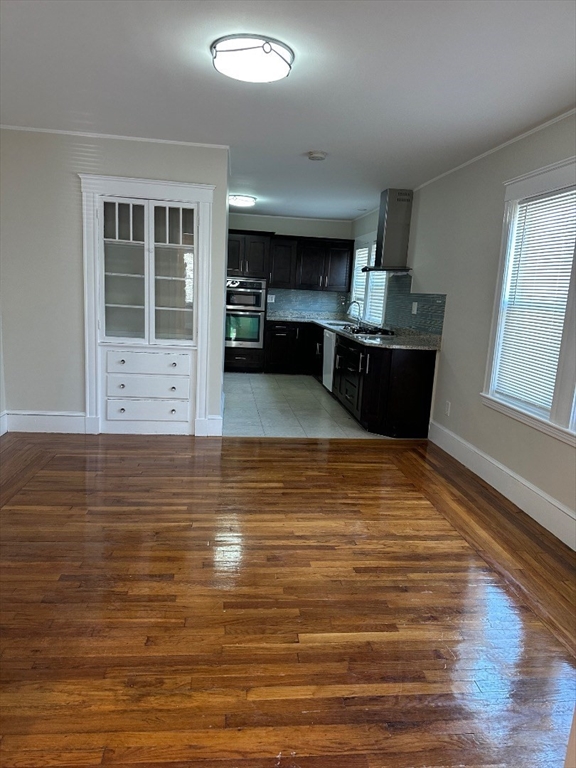 a view of kitchen with wooden cabinet and floors